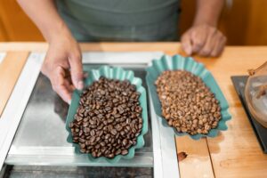 An Hispanic barista is showing different coffee beans for a sell