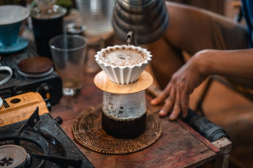 Drip coffee, barista pouring water on coffee ground with filter